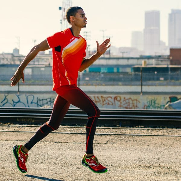 Male runner in LA running in a red, white and yellow Joma shirt, trousers and trainers