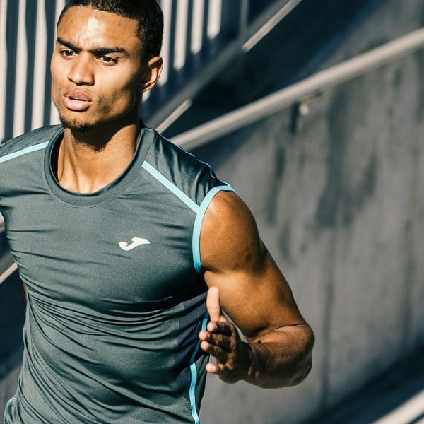 Runner wearing a turquoise Joma vest