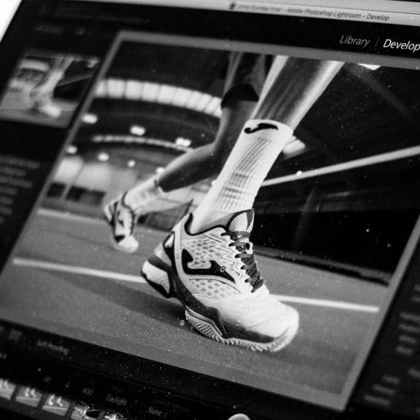 Close up photograph of a Macbook's screen showing an image of a sports trainer