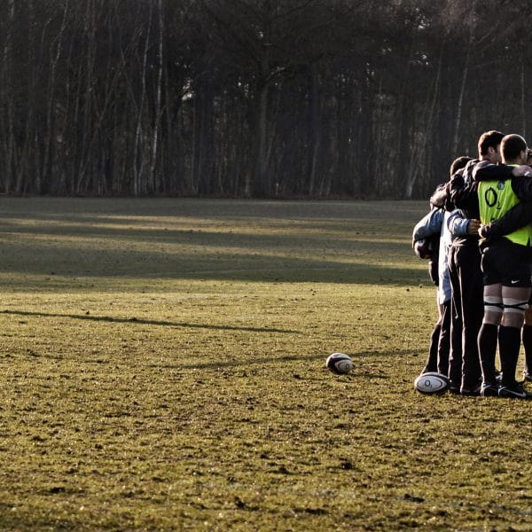 A photograph of the England Rugby team during a huddle