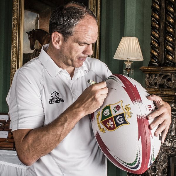 Martin johnson, English Rugby player, signing a giant Lions rugby ball
