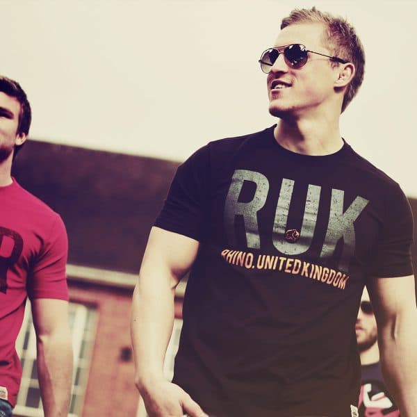 Two men wearing Rhino Rugby t-shirts in the sun