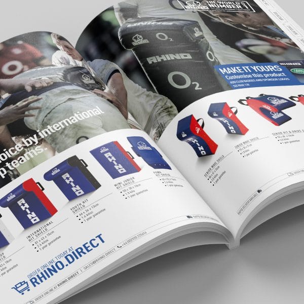 An image showing an Rhino Rugby brochure open flat on a surface