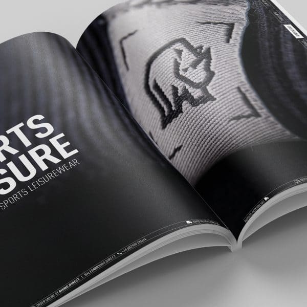 An image showing an Rhino Rugby brochure open flat on a surface