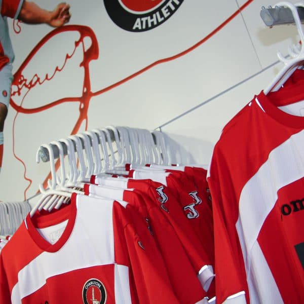 Charlton Atheltic Joma shirts hanging in the Charlton club shop