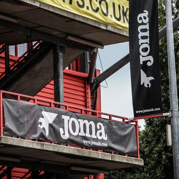 Joma banners hanging outside at a football training ground