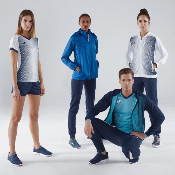 Three women and one man wearing white and blue Joma Teamwear